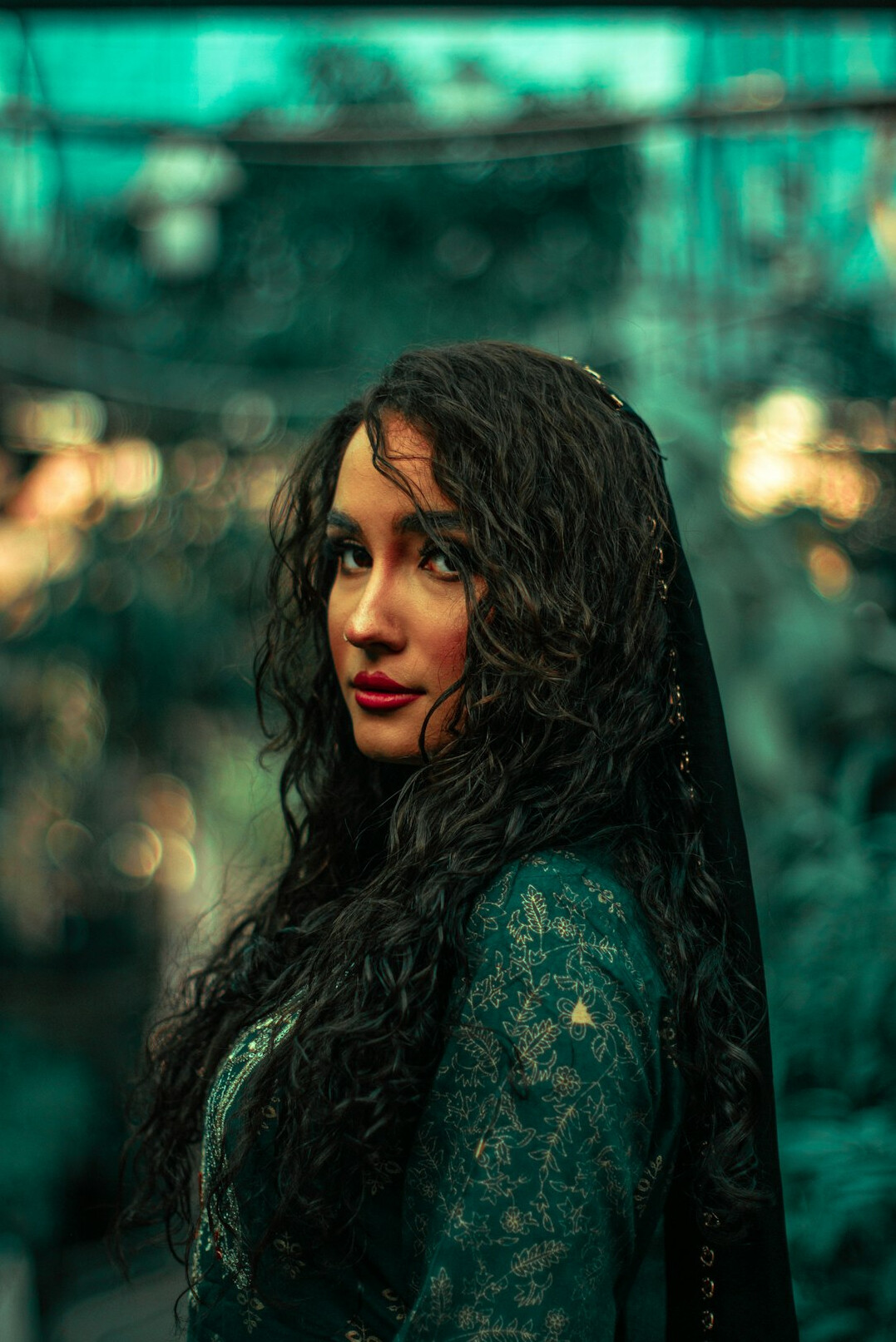 Portrait of a woman with dark curly hair smiling
