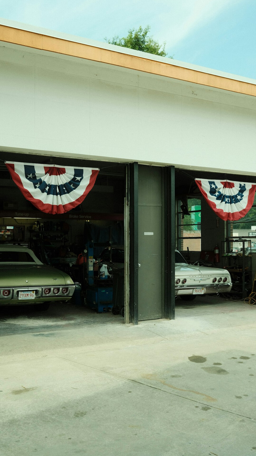 Car repair workshop with tools and a lifted car