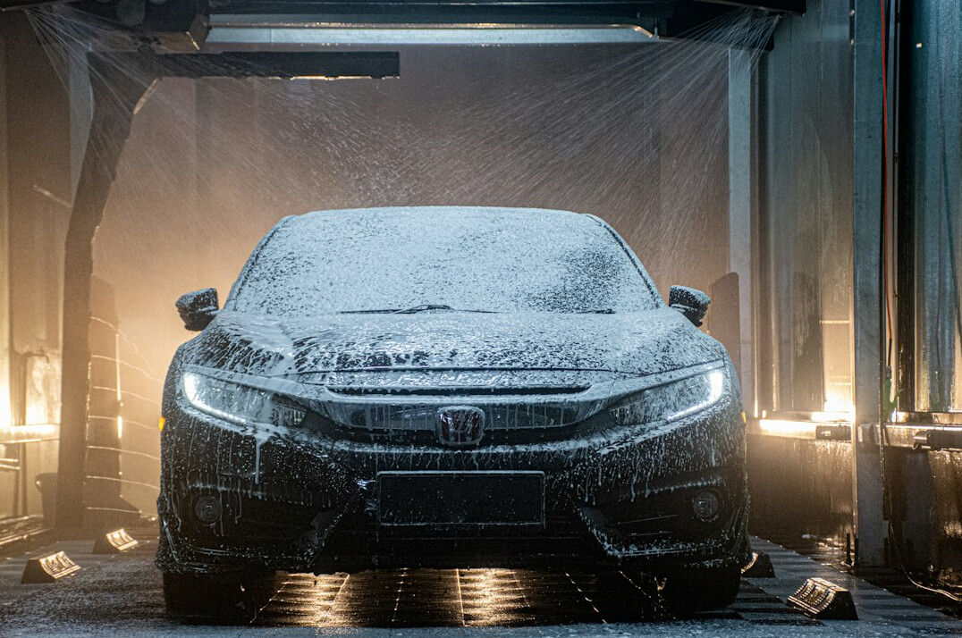 Car being washed with foam to protect the paint